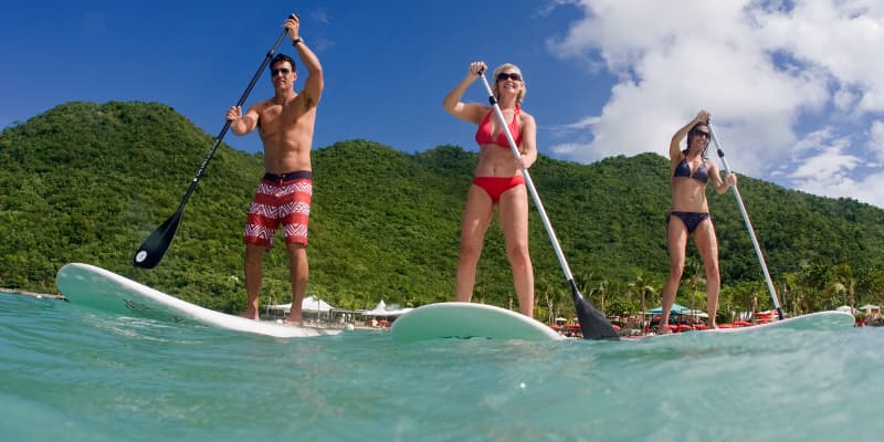three people standup paddleboarding