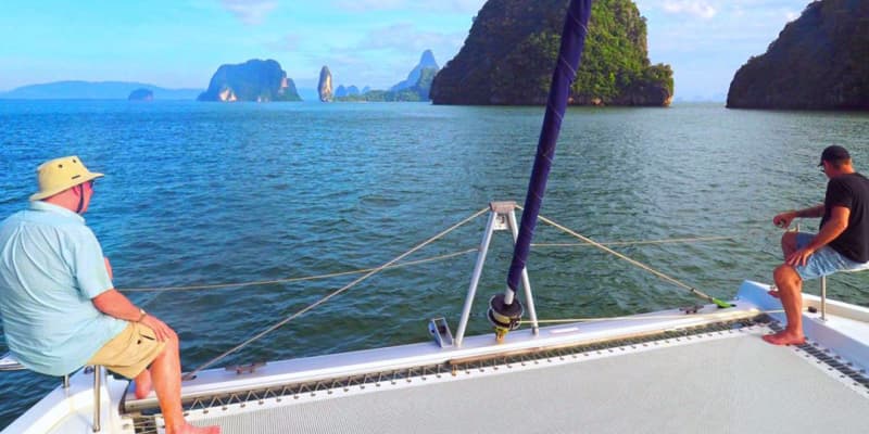 Men sailing into Koh Phing Kan